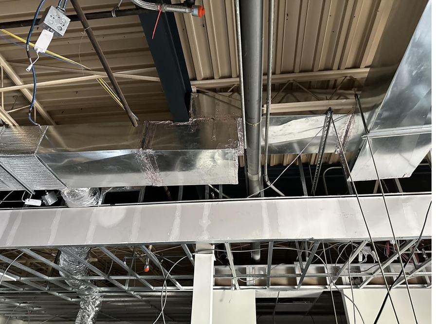 Commercial spiral and rectangular ductwork installed in an open ceiling