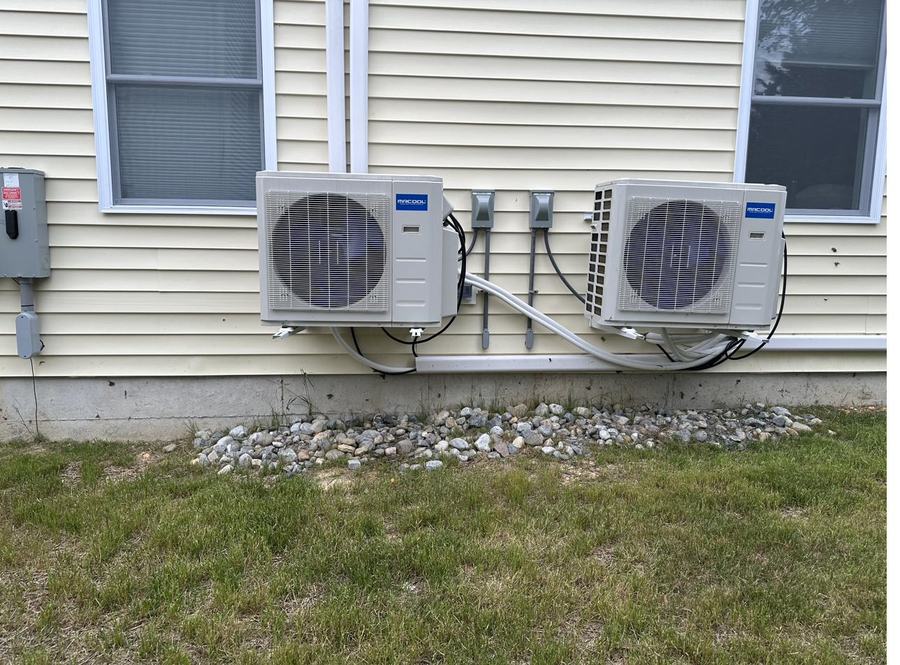 Two ductless mini-split condensers mounted outside a home